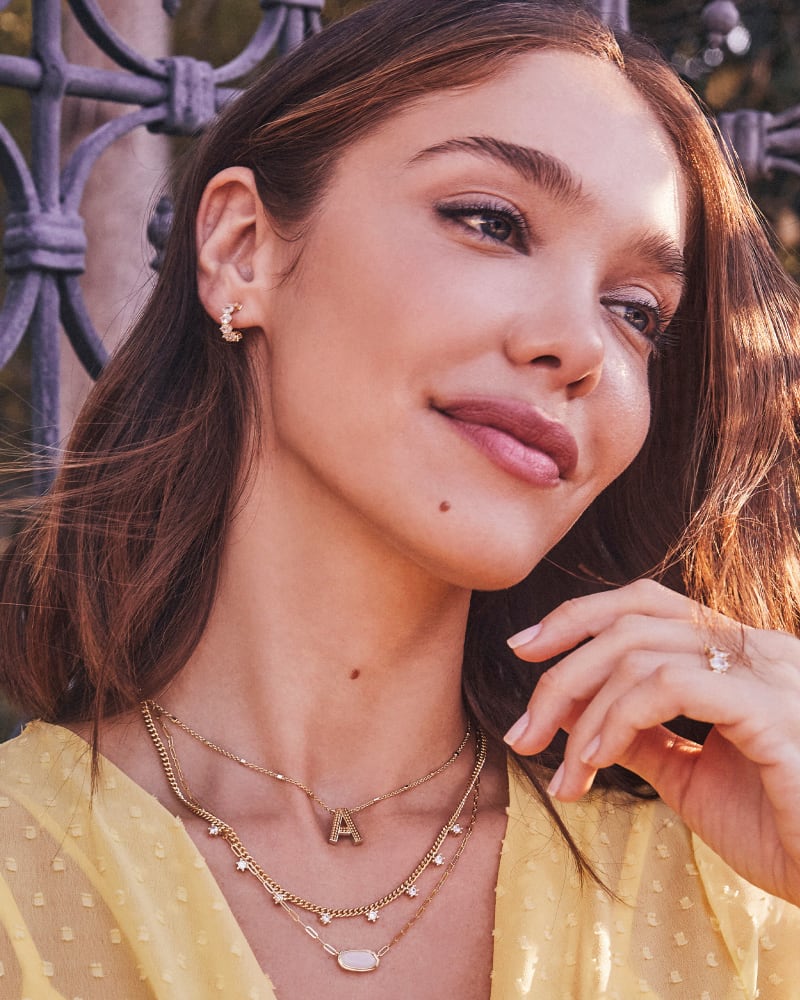 CAILIN CRYSTAL HUGGIE EARRINGS GOLD METAL WHITE CZ