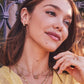 CAILIN CRYSTAL HUGGIE EARRINGS GOLD METAL WHITE CZ